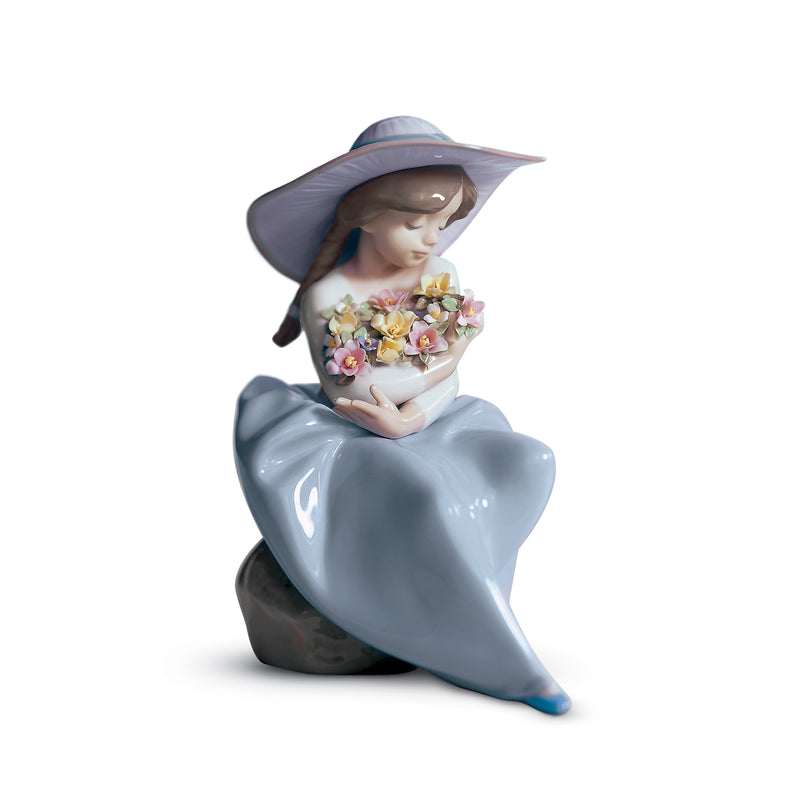Lladro porcelain figurine of a girl in a blue bonnet holding a bouquet of flowers