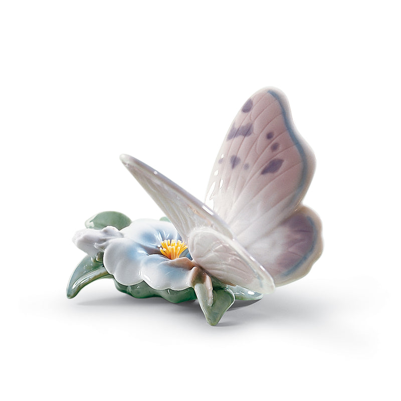 Lladro porcelain figurine of a butterfly with a white flower and blue wings