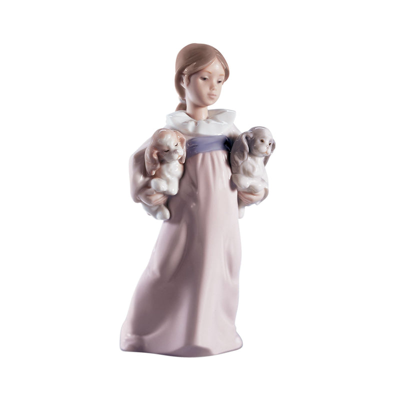 Porcelain figurine of a girl in a lavender dress holding two puppies in her arms