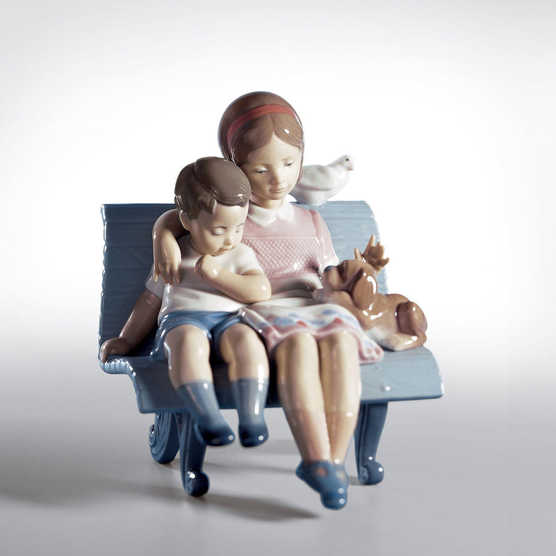 Lladro porcelain figurine of a mother seated on a couch holding two children