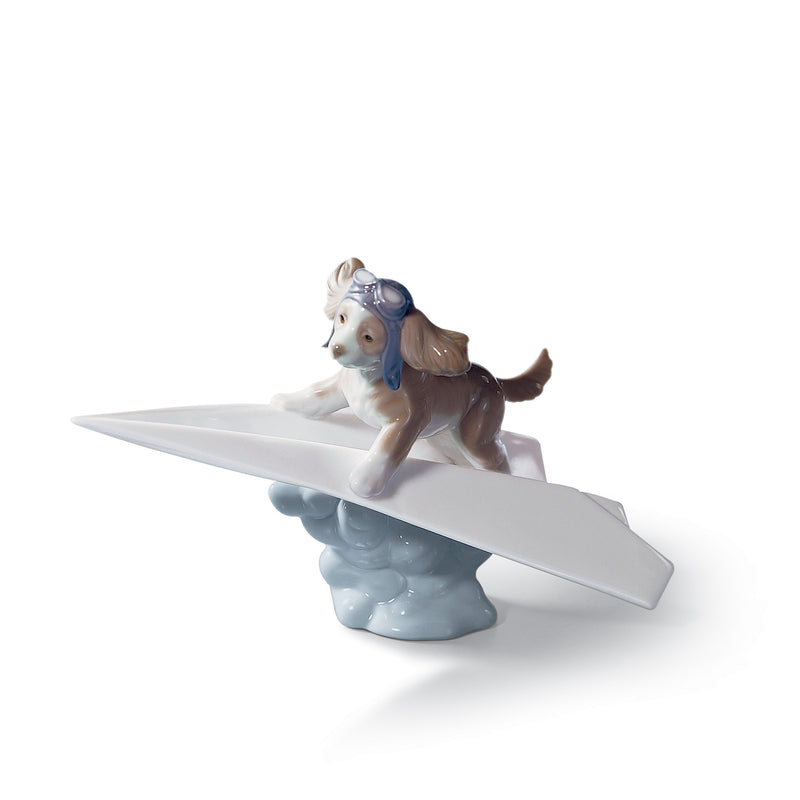 Lladro porcelain figurine of a small dog with blue hat on a white airplane wing