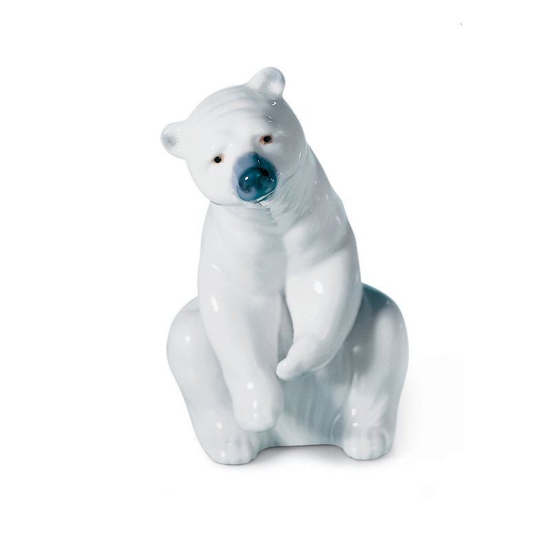 Lladro porcelain polar bear figurine, resting pose with blue nose and painted eyes