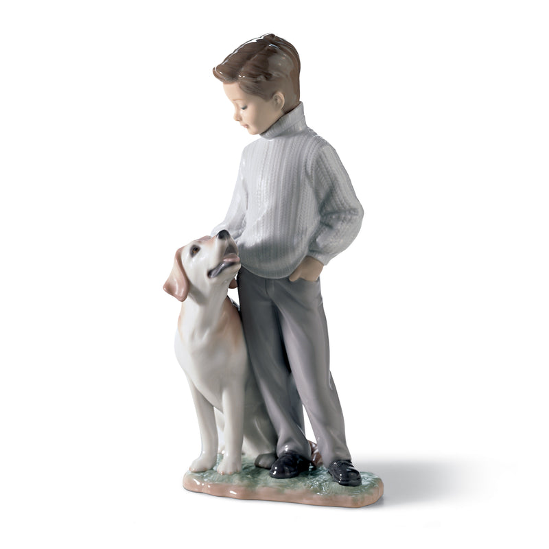 Porcelain figurine of a child in a light gray coat standing beside a white dog