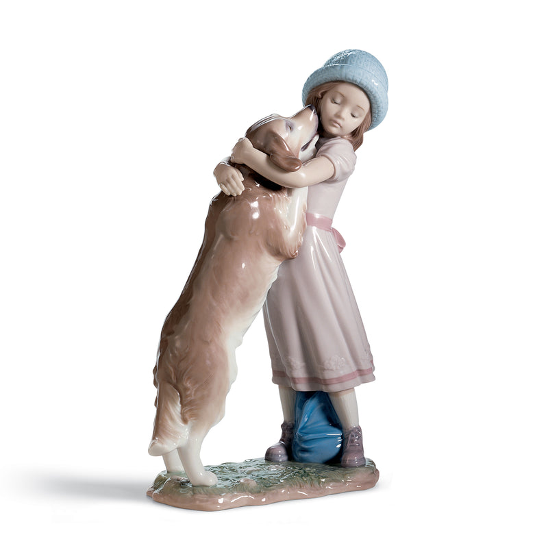 Porcelain figurine of a girl in a blue hat holding a brown-and-white dog