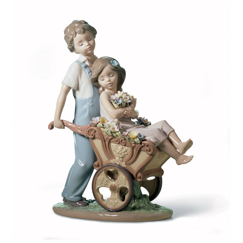 Lladro porcelain figurine of two children with a decorated wheelbarrow