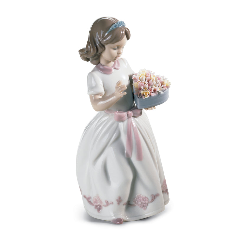 Lladro porcelain figurine of a girl in a pale dress holding a flower bouquet