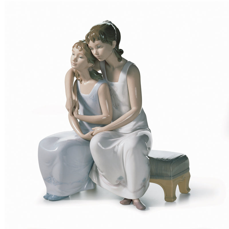 Lladro porcelain figurine of two seated women embracing, light blue and white dresses