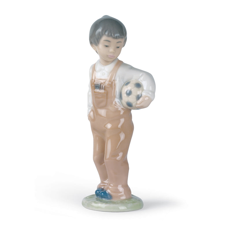 Nao porcelain figurine of boy holding a spotted dog, blue shoes, beige glaze