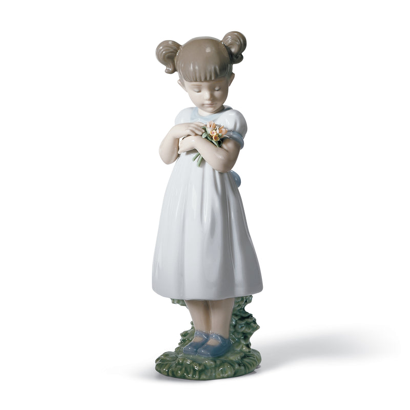 Lladro porcelain figurine of a girl holding colorful flowers, white dress on green base