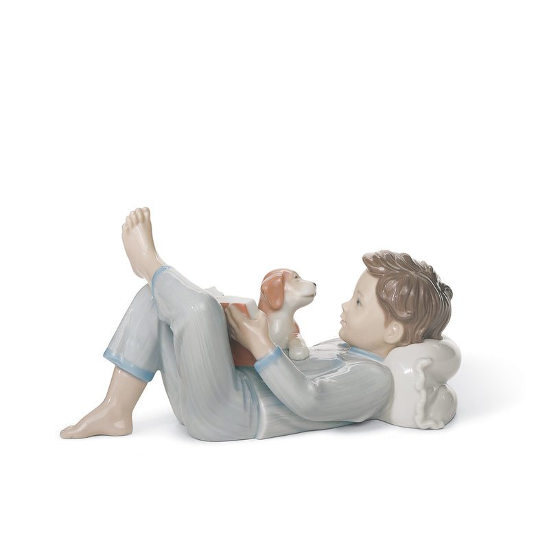Lladro porcelain figurine of a reclining child reading beside a small animal
