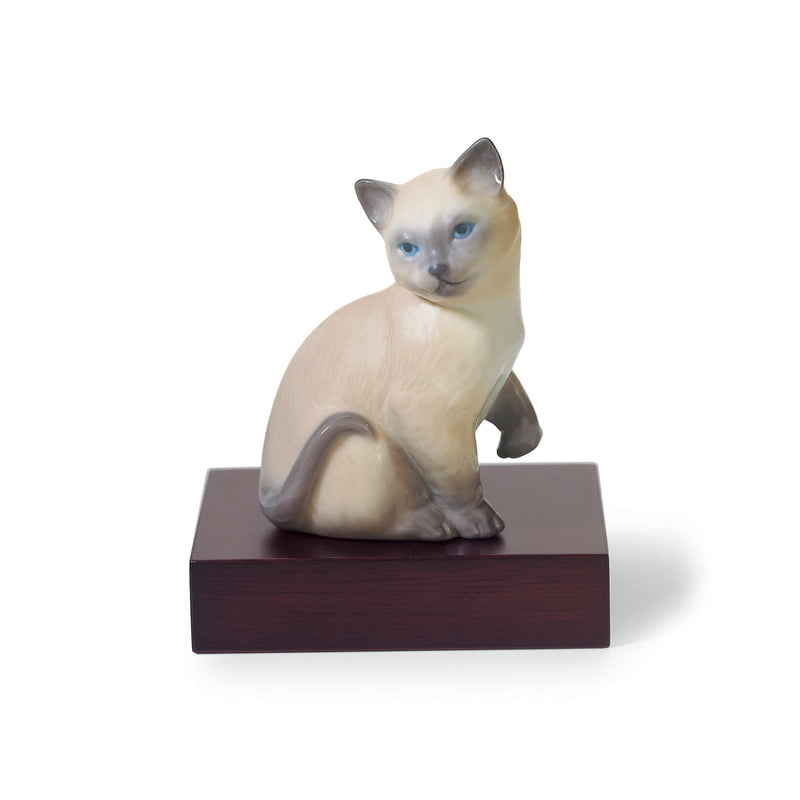 Lladro porcelain lucky cat figurine, cream body with blue eyes, seated on dark base