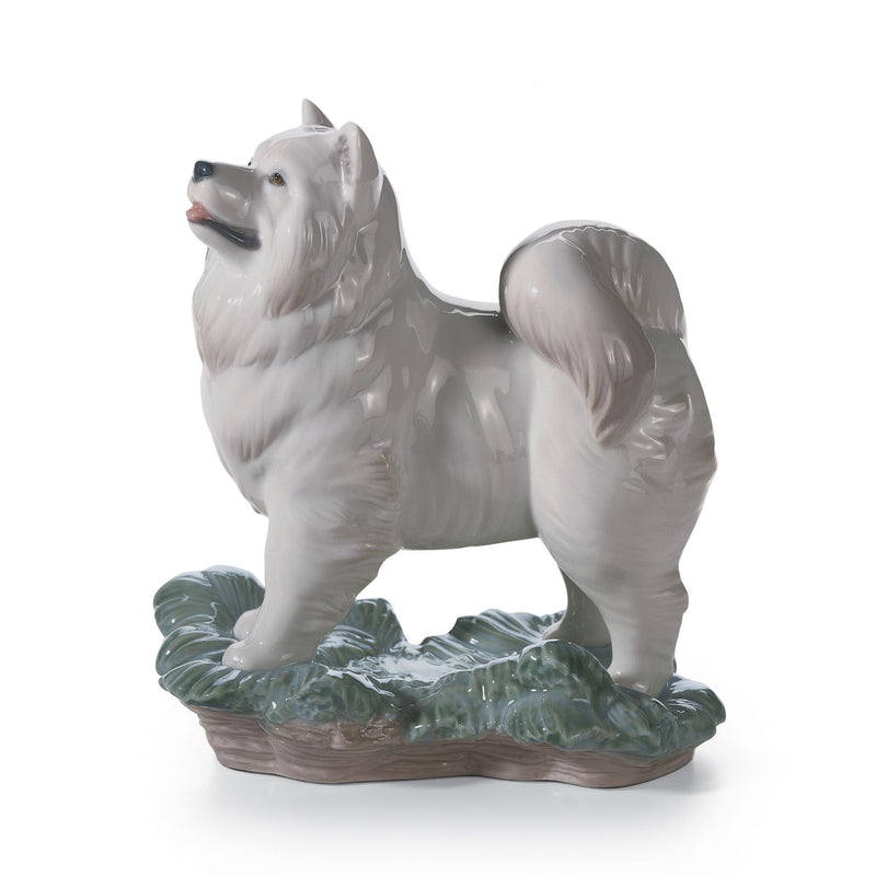 Lladro white porcelain dog figurine, seated on green textured base