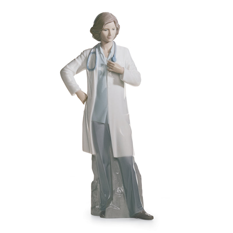 Lladro female doctor porcelain figurine, white coat, teal dress, holding stethoscope