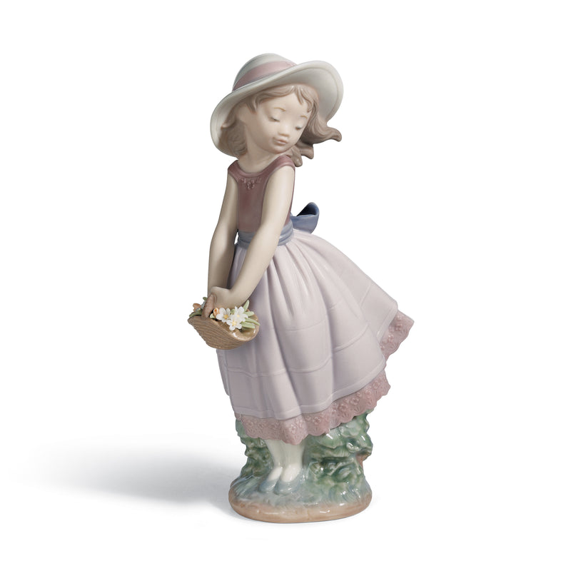 Porcelain figurine of a girl in a bonnet and purple dress holding a flower basket