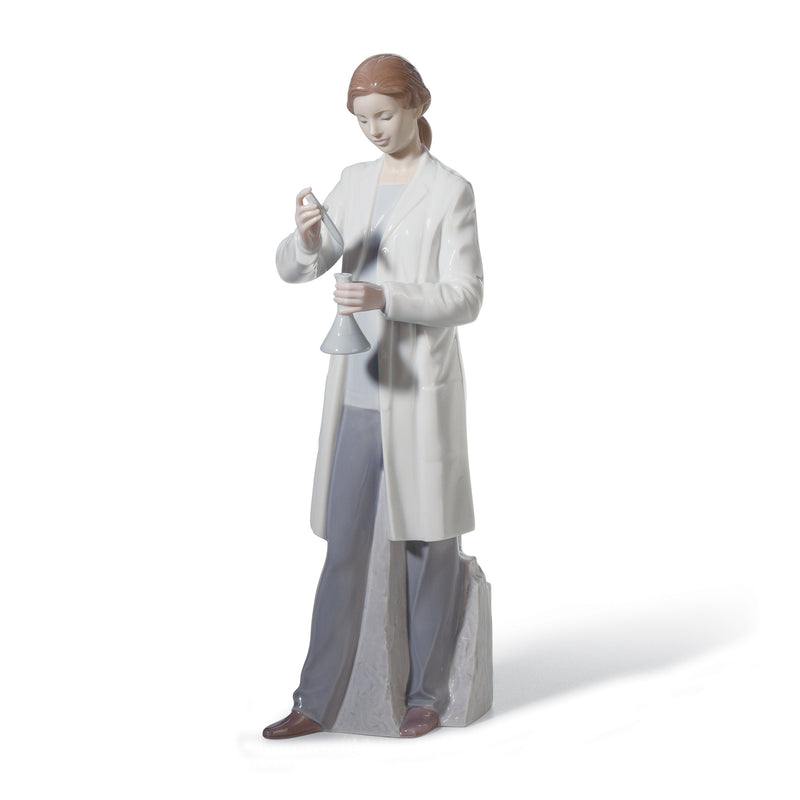 Lladro porcelain figurine of a woman in lab coat holding a small tool