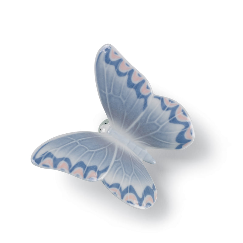 Porcelain butterfly figurine with light-blue wings and painted wave pattern