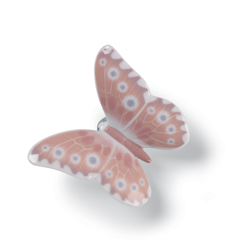 Porcelain butterfly figurine with pink and orange patterned wings