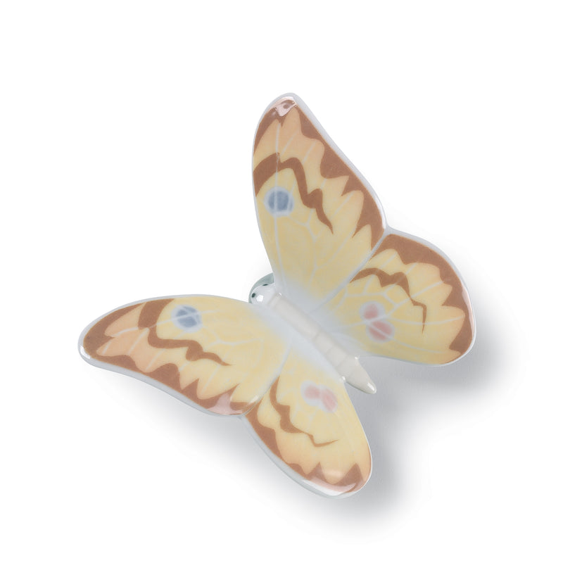 Porcelain butterfly figurine in honey-gold and brown with blue flower accents