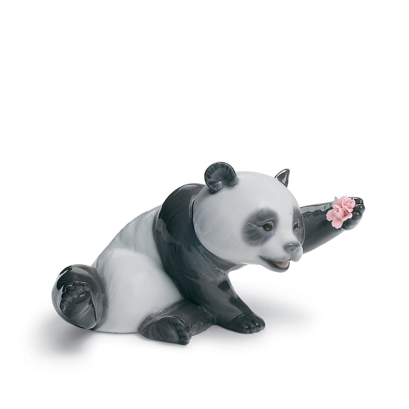 Lladro porcelain panda figurine, sitting and holding a pink flower