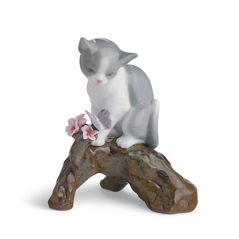 Lladro porcelain cat figurine holding pink blossoms in its paws