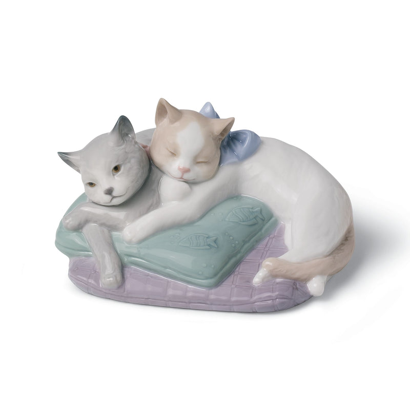 Porcelain cat figurine with two snuggling cats on pastel cushion, blue and pink details