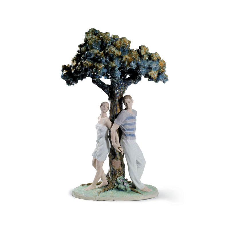 Lladro porcelain figurine with two lovers under a blue-green flowering tree on a base