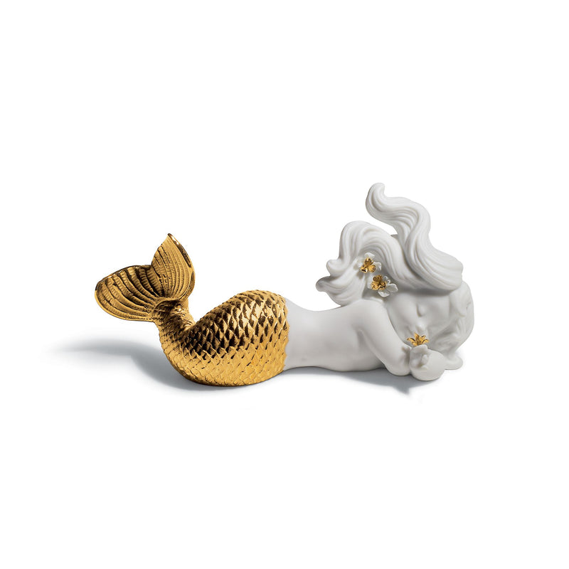 Golden and white porcelain sea figurine with reclining shell and flower accents