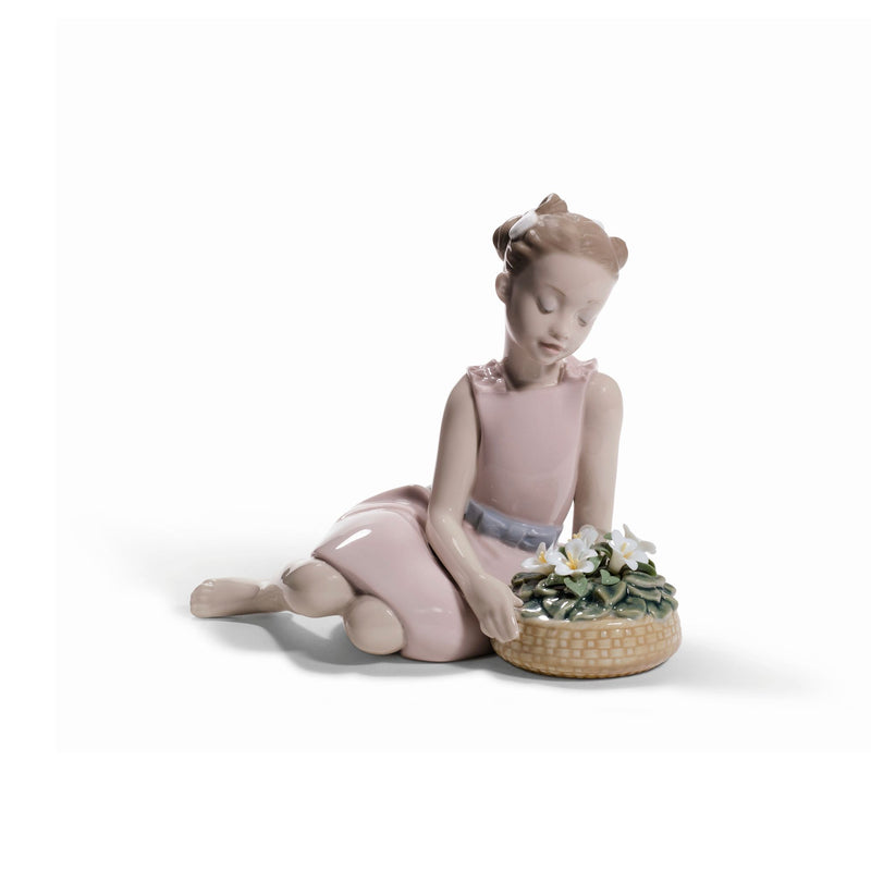 Lladro porcelain flower arrangement figurine: seated girl placing flowers in basket