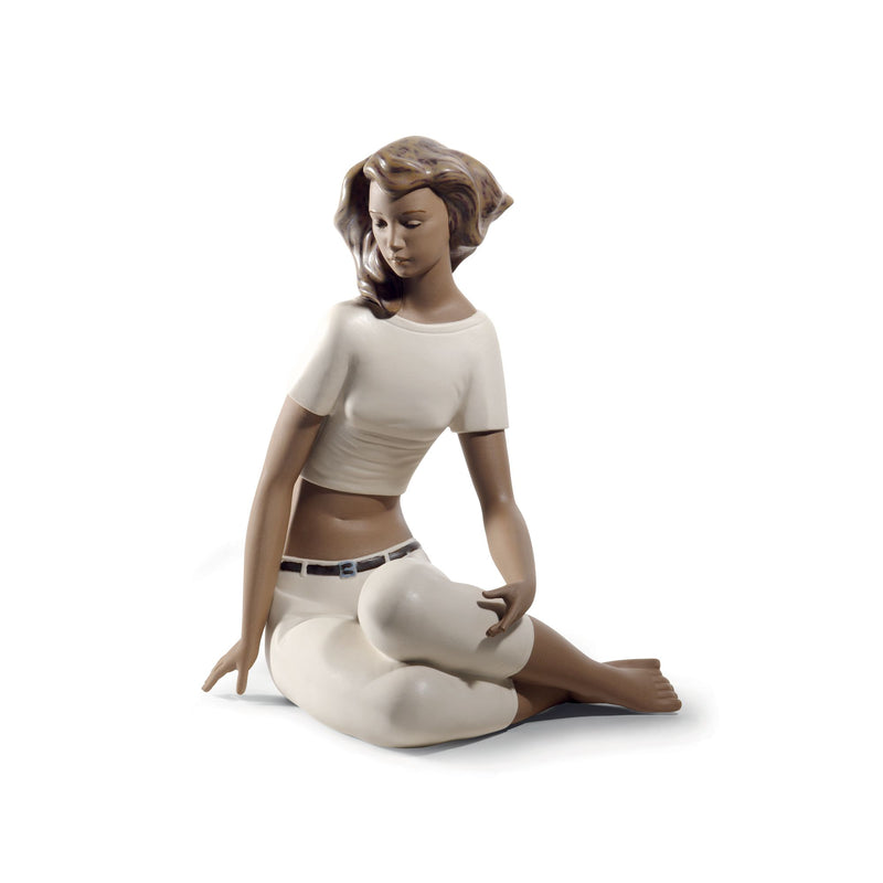Porcelain figurine of a seated woman holding a small companion figure