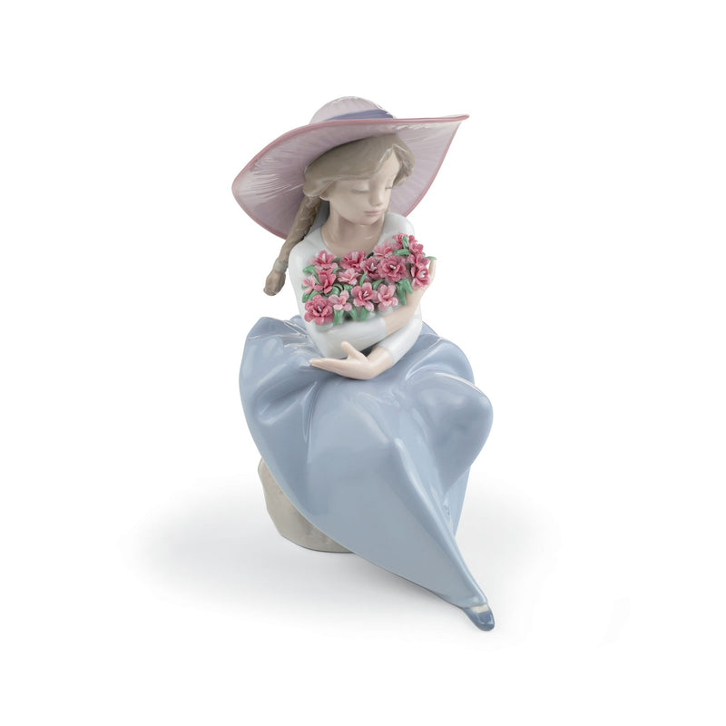 Lladro porcelain figurine of a girl in blue dress, holding a pink flower bouquet