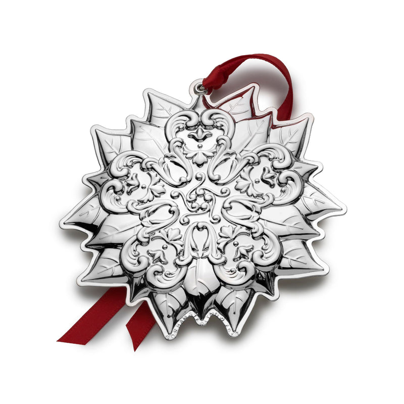 Sterling silver poinsettia ornament with red ribbon and detailed leaf filigree