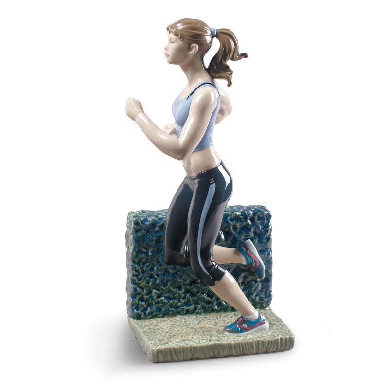 Porcelain figurine of a running woman in blue top, black leggings, and red-blue shoes