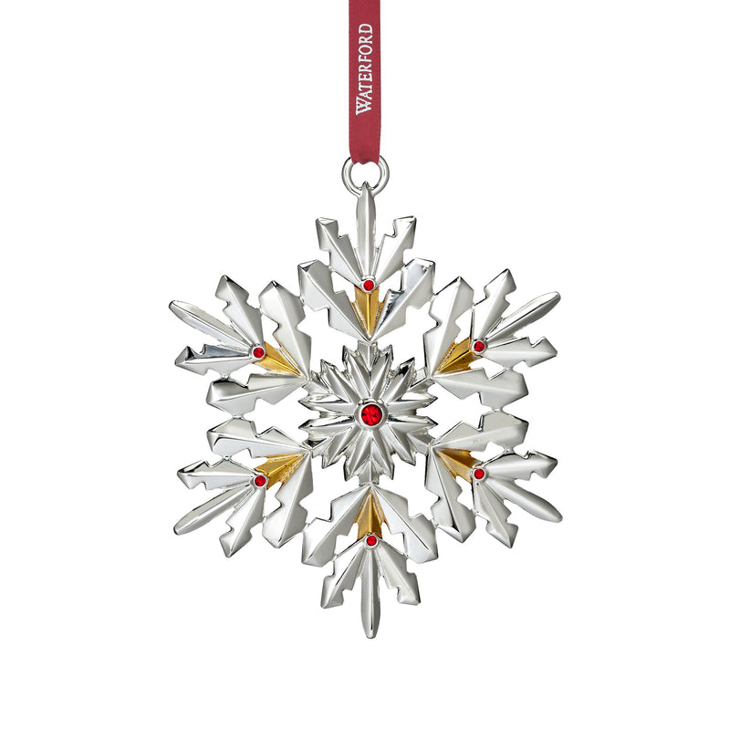 Silver plate snowflake ornament with red accents, hanging on a red ribbon loop