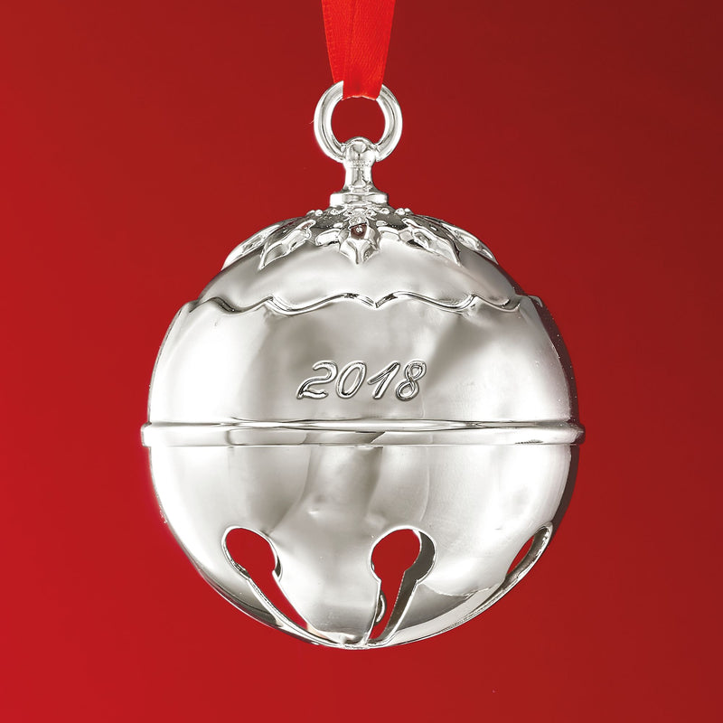 Silver-tone bell ornament with holly top, 2018 engraving, red ribbon loop