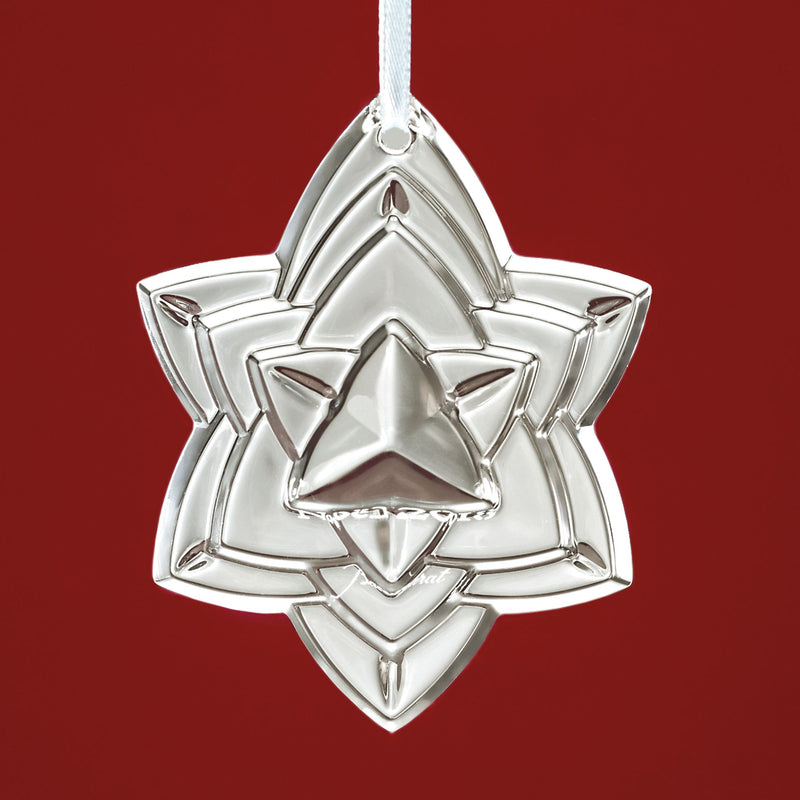 Baccarat crystal star ornament with hanging loop, faceted star design, silver tone