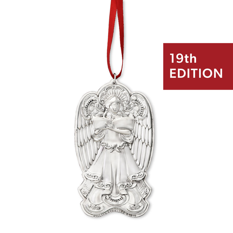 Sterling silver angel ornament with detailed wings and robe, hanging on red ribbon loop
