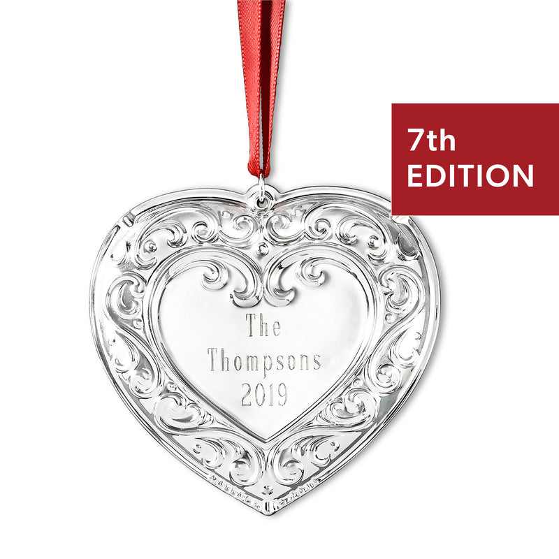 Silver heart ornament with engraved 'The Thompsons 2019' and red ribbon, 7th edition