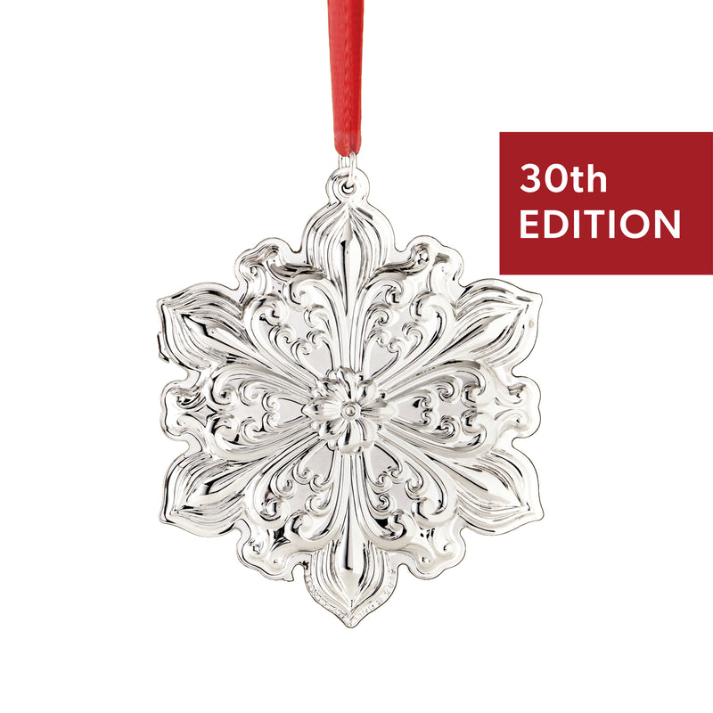 Sterling silver snowflake ornament with hanging red ribbon, intricate floral filigree