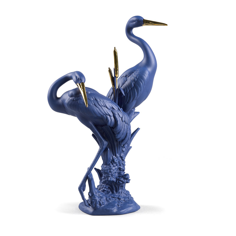Blue and gold porcelain crane figurine with two birds posed in courting stance