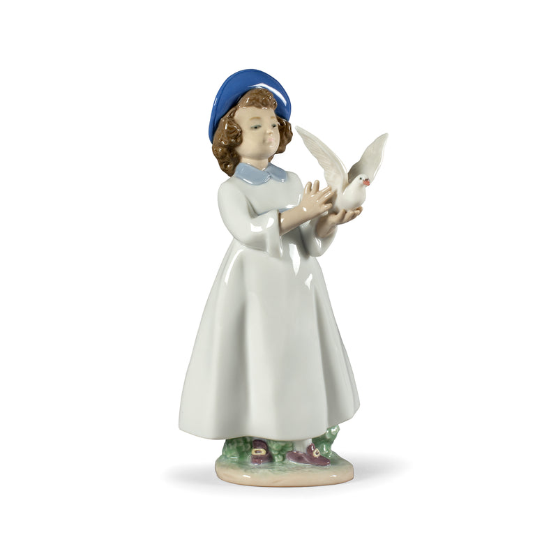 Porcelain angel figurine in white dress with blue hat, holding a white bird.
