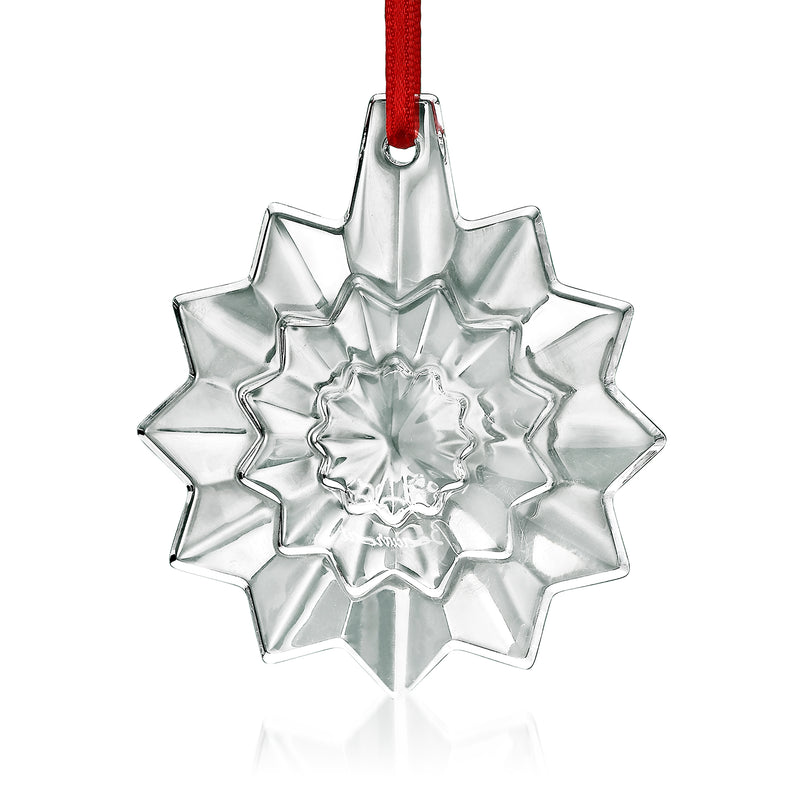 Baccarat crystal snowflake ornament with red ribbon loop, starburst cut glass design