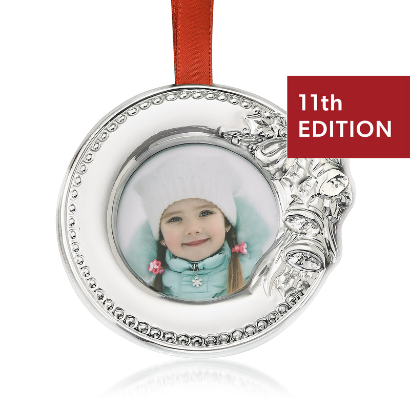 Silver-tone round photo frame ornament with hanging ribbon, oval photo window, 11th Edition