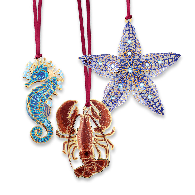 Set of 3 sea life ornaments: blue starfish, seahorse, and red crab with ribbons