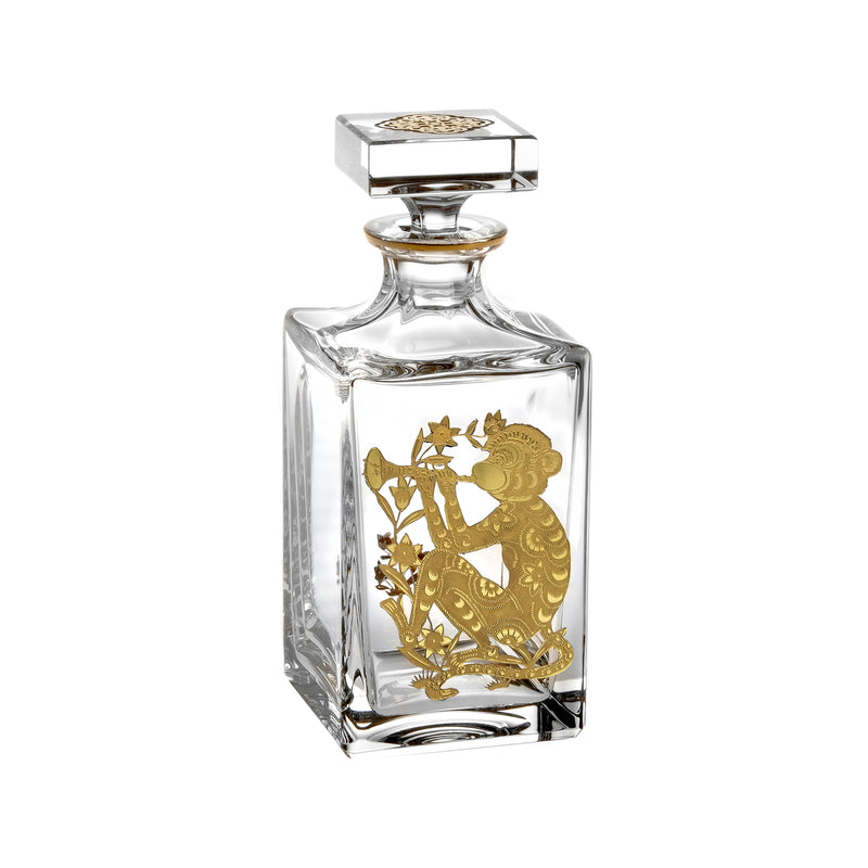Glass whiskey decanter with gold monkey and floral relief, faceted square stopper
