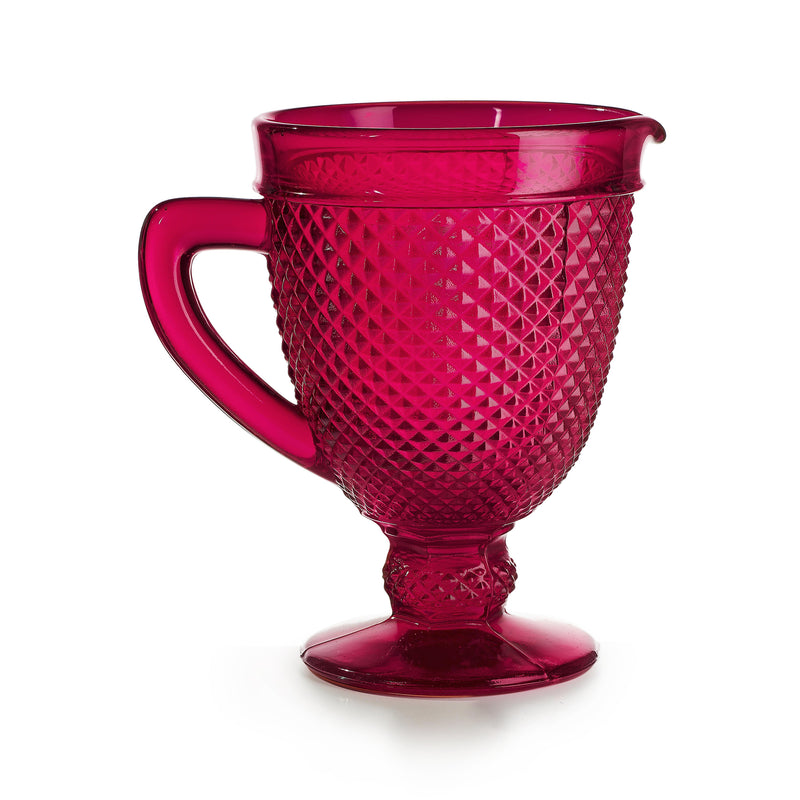 Vista Alegre red glass pitcher with faceted pattern, curved handle and pedestal base