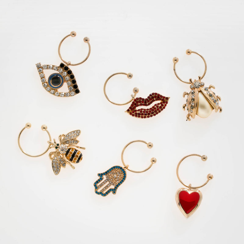 Set of 6 gold-tone wine charms with rhinestone evil eye, lips, heart, and other charms