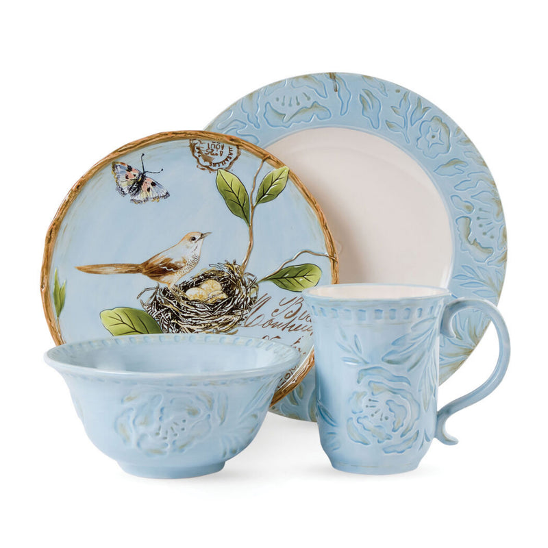 Ceramic 4-piece place setting with blue textured glaze and bird-and-leaf motif plates and bowls.