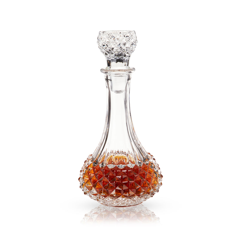 Studded glass decanter with faceted stopper; amber-tinted cut-glass body