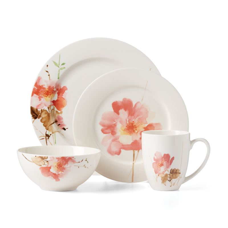Porcelain dinnerware set with pink and peach floral accents: plate, bowl, and mug.