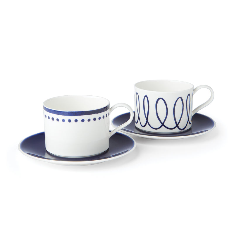 Porcelain cup and saucer set, two white cups with blue patterned rims and saucers